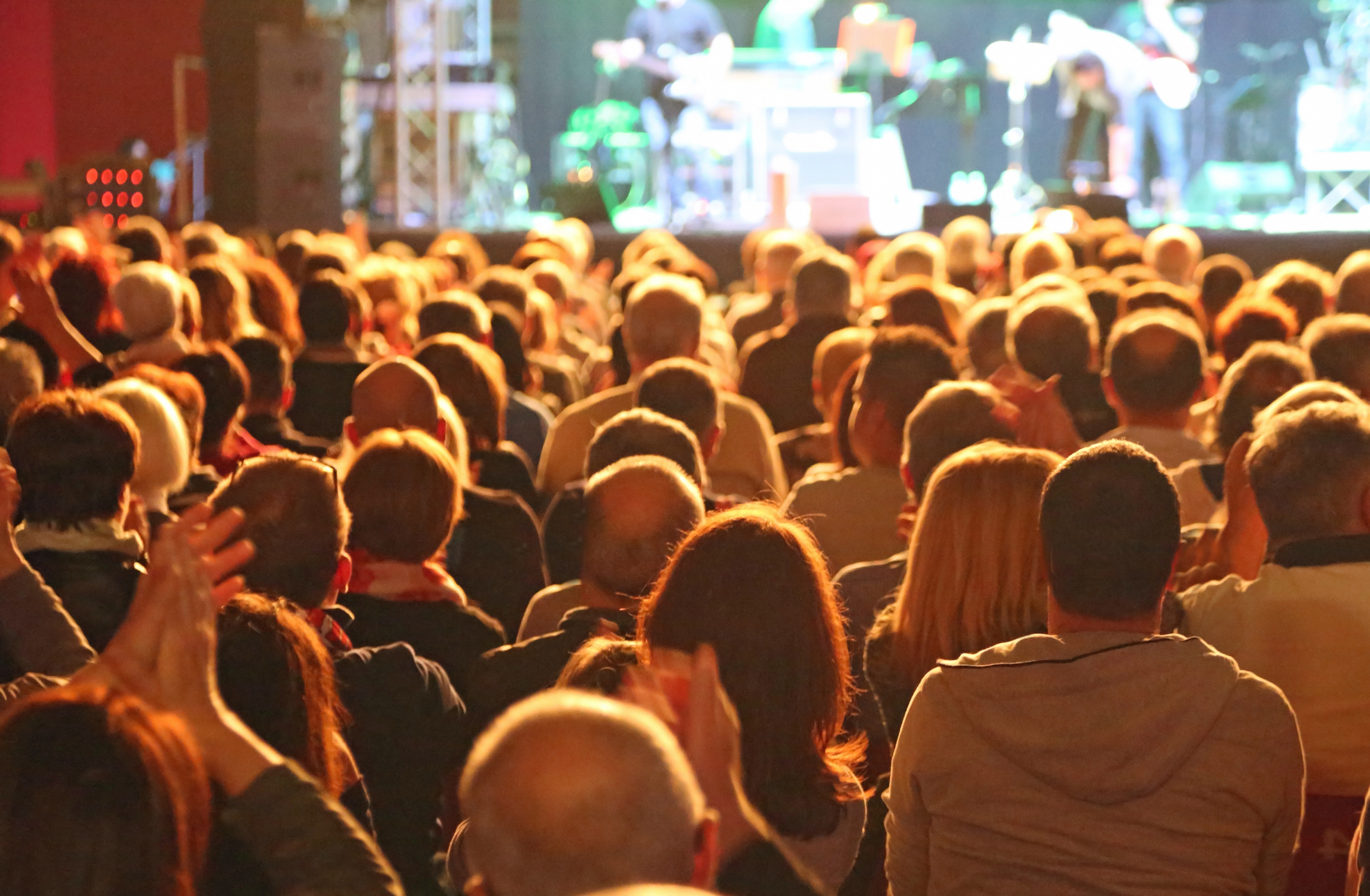 Audience watching a theatre show that is sustainable from a financial perspective